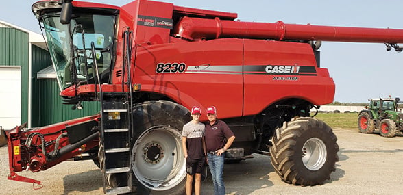 People standing infront of Axial Flow CASE IH Combine